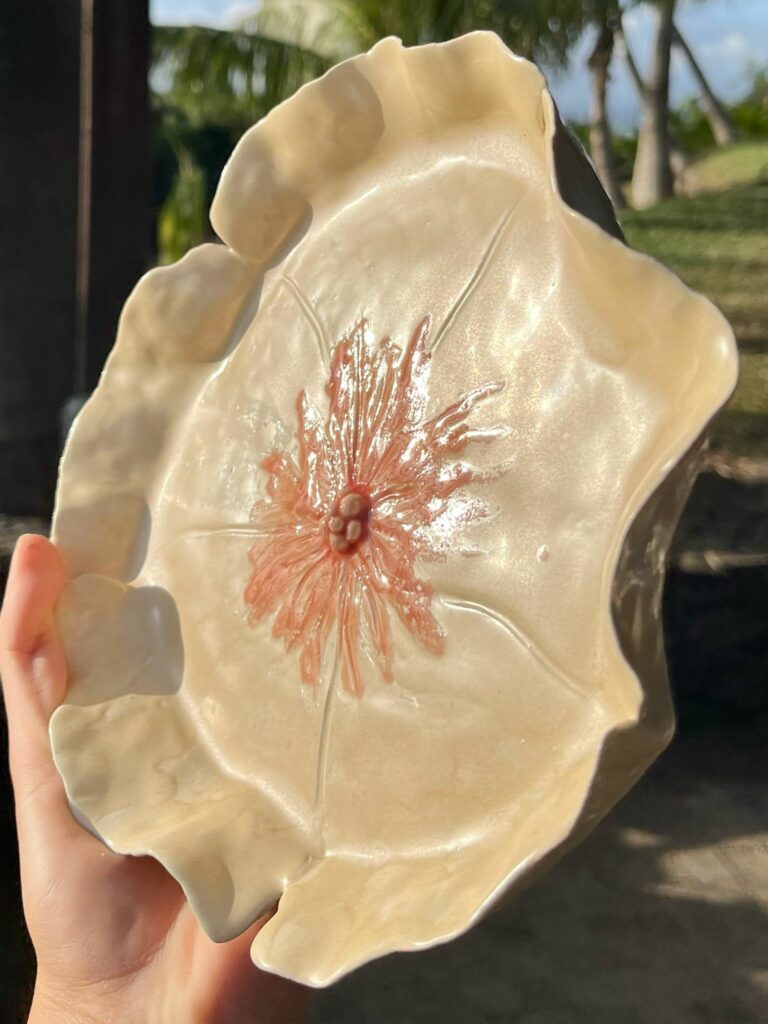 Pièce de céramique émaillée avec motif floral en relief.